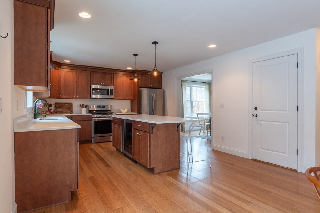 188 South Road Pepperell, MA 01463 - Photo 11 of 41 a kitchen with kitchen island wooden floors wooden cabinets and appliances