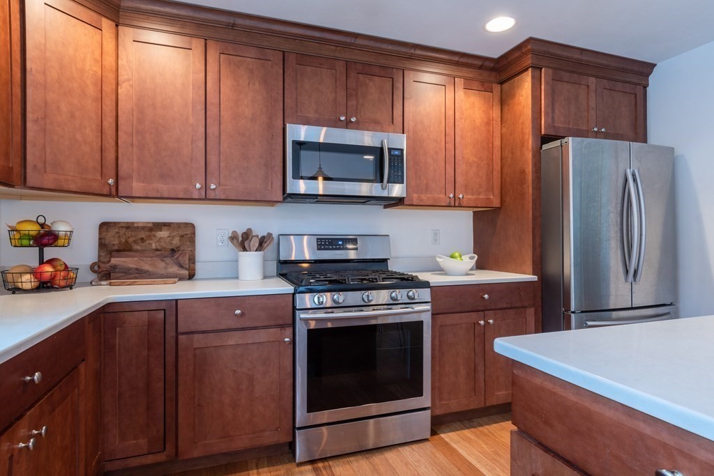 188 South Road Pepperell, MA 01463 - Photo 14 of 41 a kitchen with stainless steel appliances granite countertop a stove a refrigerator and a sink with wooden cabinets