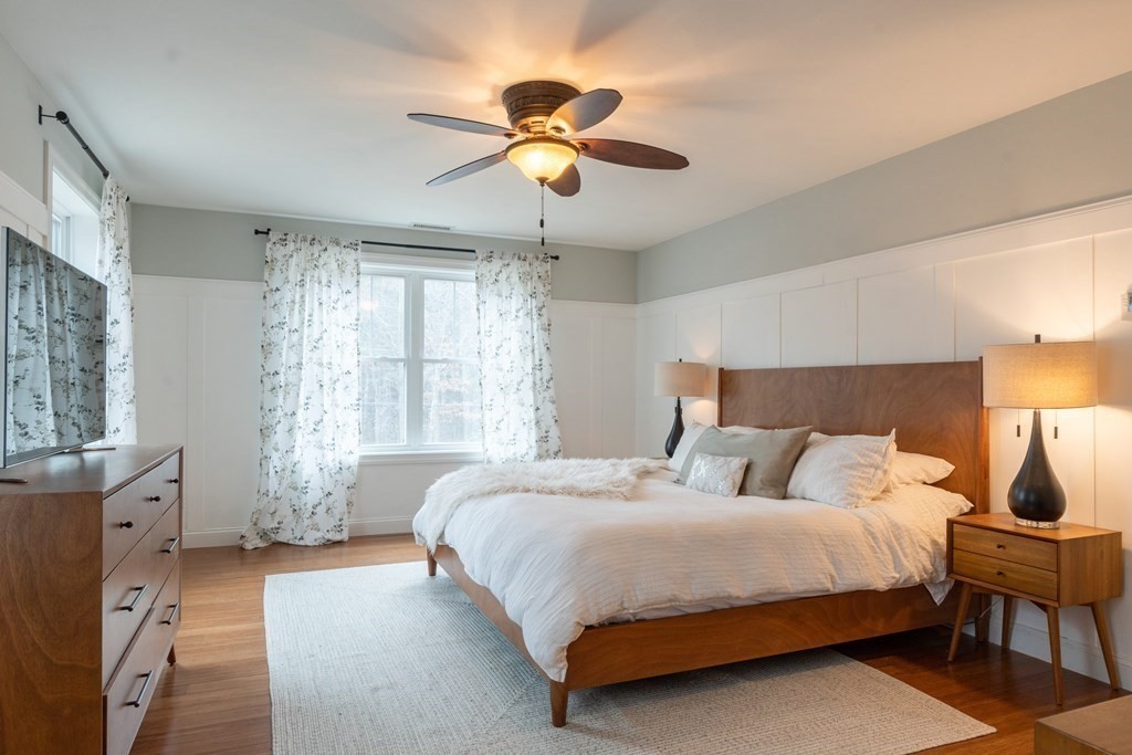 188 South Road Pepperell, MA 01463 - Photo 24 of 41 a bedroom with a large bed and a chandelier