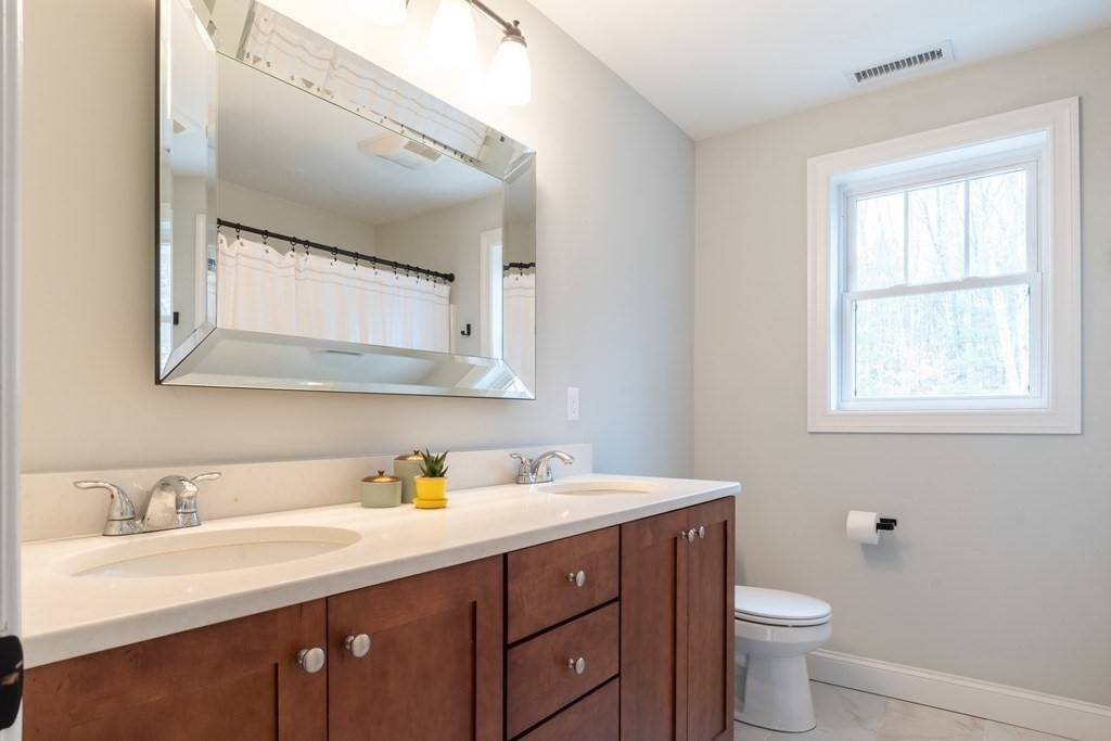 188 South Road Pepperell, MA 01463 - Photo 25 of 41 a bathroom with a toilet sink and mirror