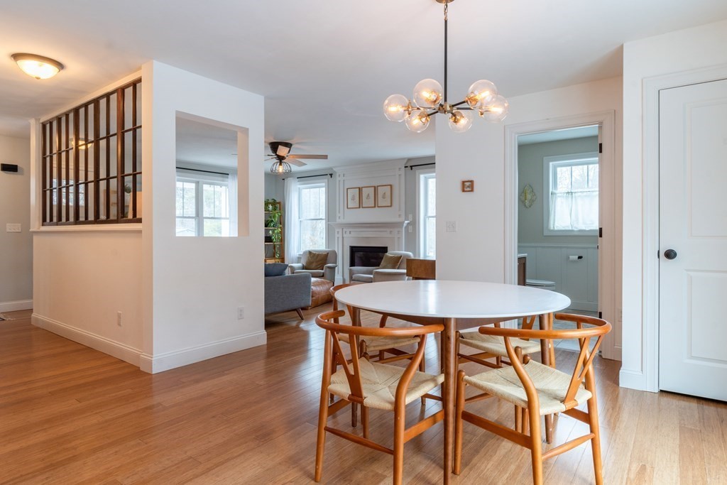 188 South Road Pepperell, MA 01463 - Photo 34 of 41 a dining room with wooden floor a chandelier a wooden table and chairs