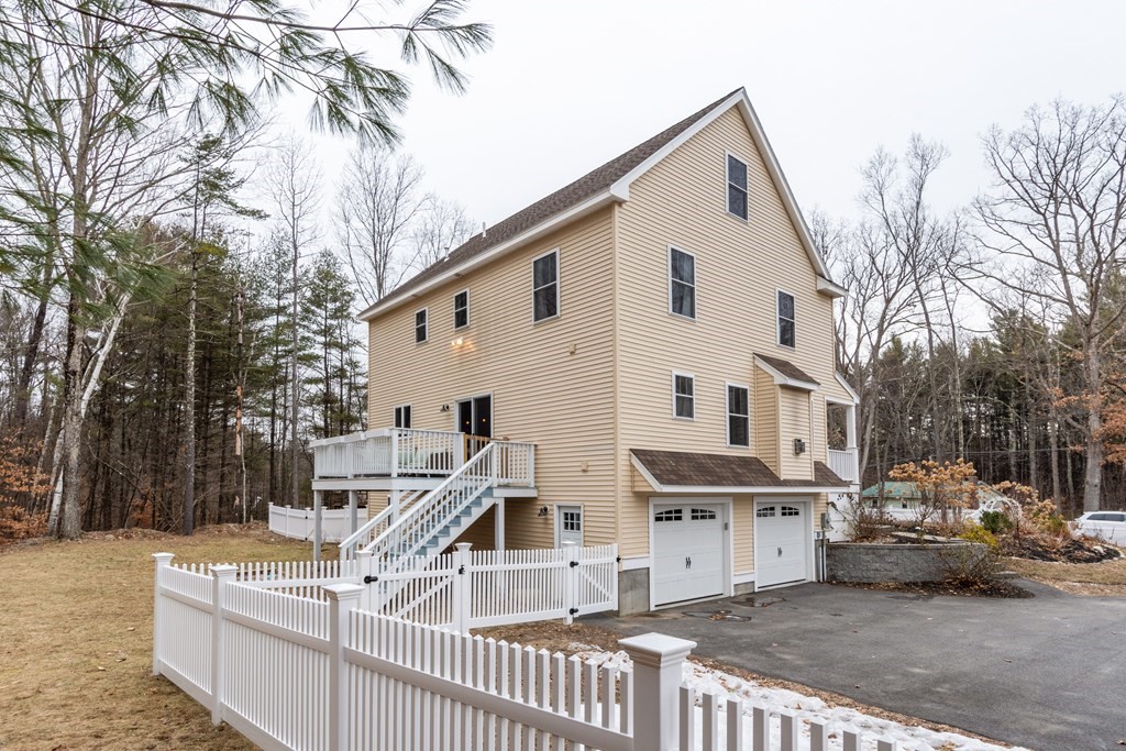 188 South Road Pepperell, MA 01463 - Photo 39 of 41 a view of a white house with large trees and wooden fence