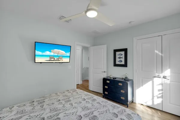 a bedroom with a bed and a flat screen tv