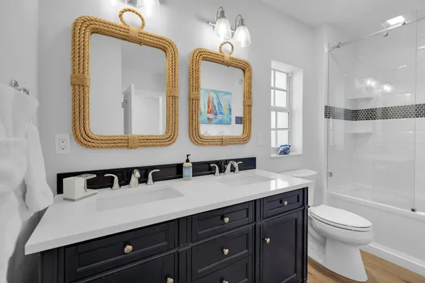a bathroom with a shower sink and mirror
