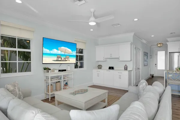 a kitchen with a dining table chairs refrigerator and cabinets