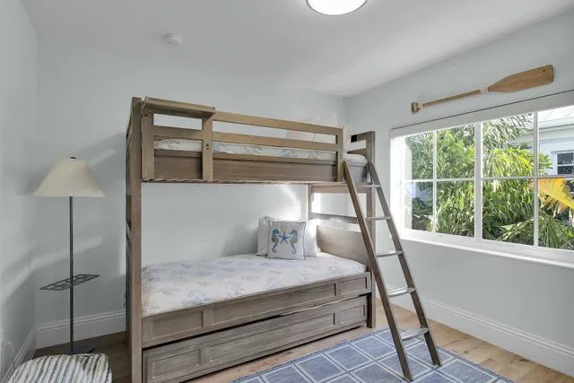 a bedroom with a large bed and a window