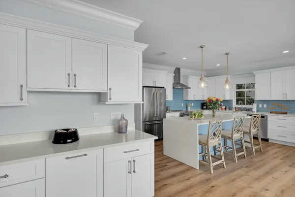 a kitchen with refrigerator and chairs