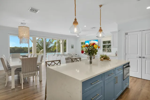 a view of a dining room with furniture large windows and wooden floor