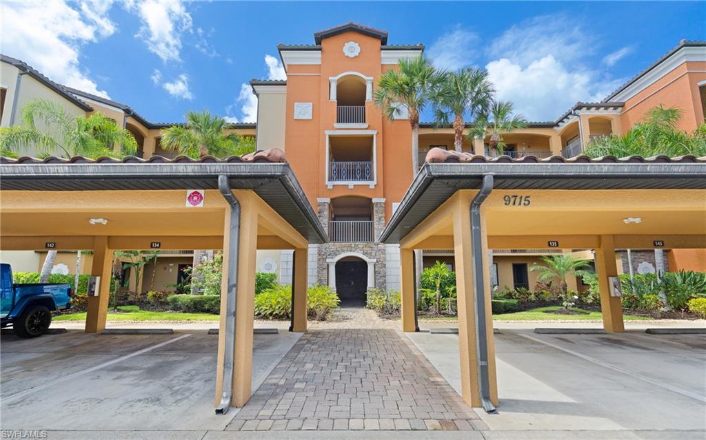 9715 Acqua Court, Unit 116 Naples, FL 34113 - Photo 20 of 43 a front view of a building with glass windows and door