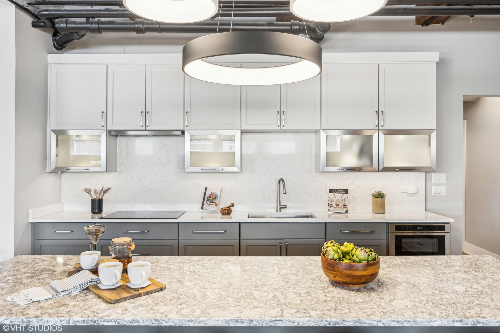 411 South Sangamon Street, Unit B Chicago, IL 60607 - Photo 9 of 24 a kitchen with a sink a stove and white cabinets with wooden floor