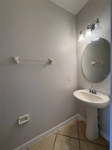 a bathroom with a sink toilet and a mirror