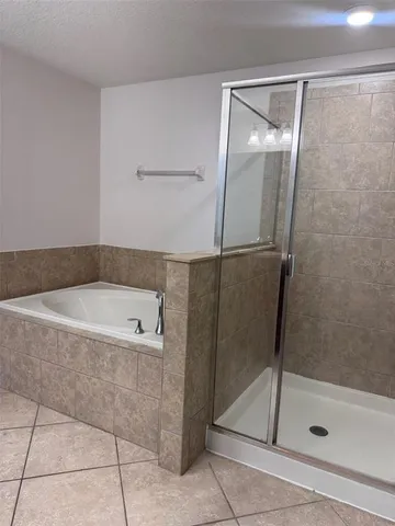a bathroom with a granite countertop sink toilet mirror and bathtub