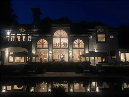 a front view of a house with lots of swimming pool and outdoor seating