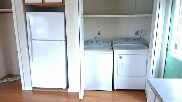 a kitchen with a sink wooden floor and a window