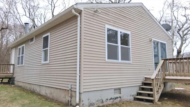 a backyard of a house with table and chairs