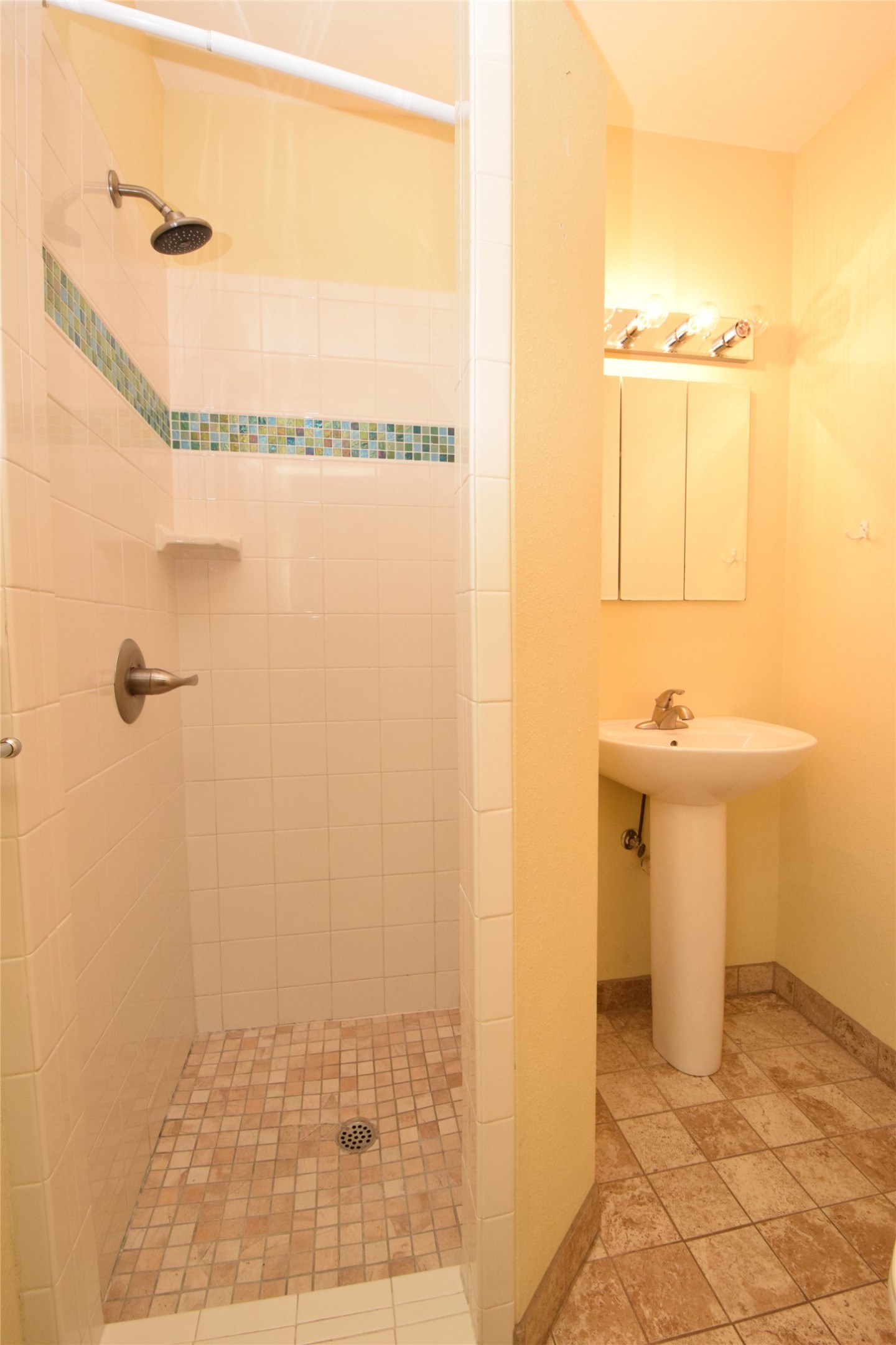 2801 Lafayette Avenue, Unit B Austin, TX 78722 - Photo 8 of 13 Full bathroom featuring baseboards, stone finish floor, a shower stall, and a sink