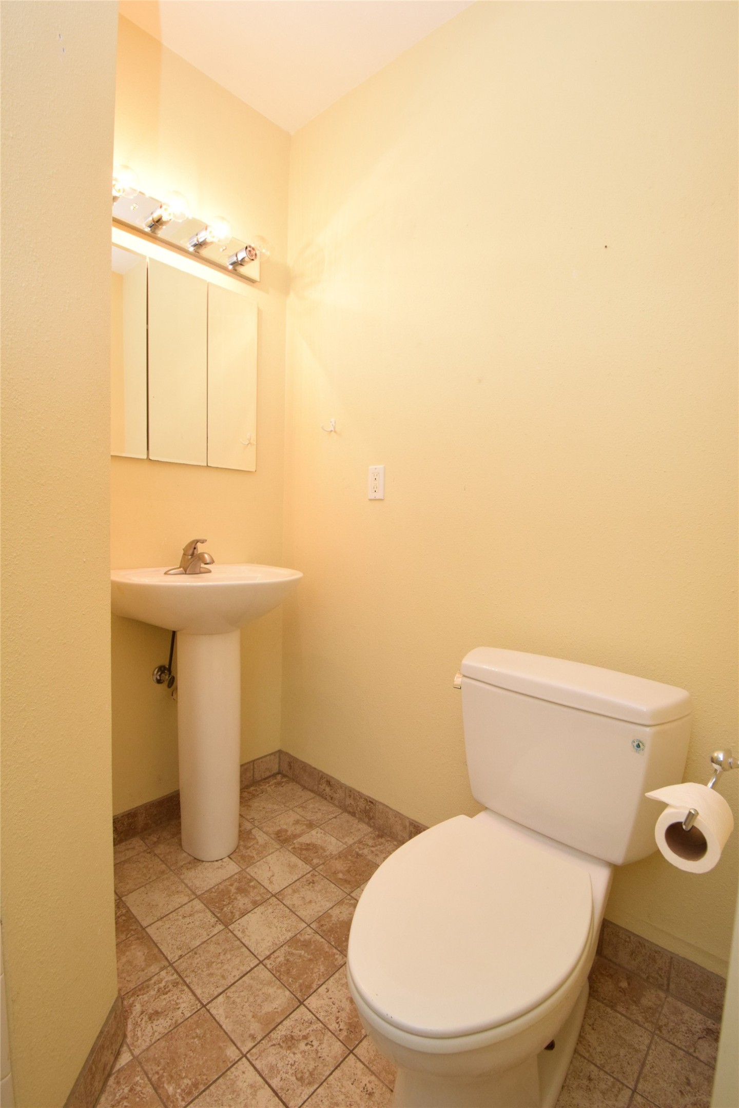 2801 Lafayette Avenue, Unit B Austin, TX 78722 - Photo 9 of 13 Bathroom with toilet, stone tile floors, a sink, and baseboards