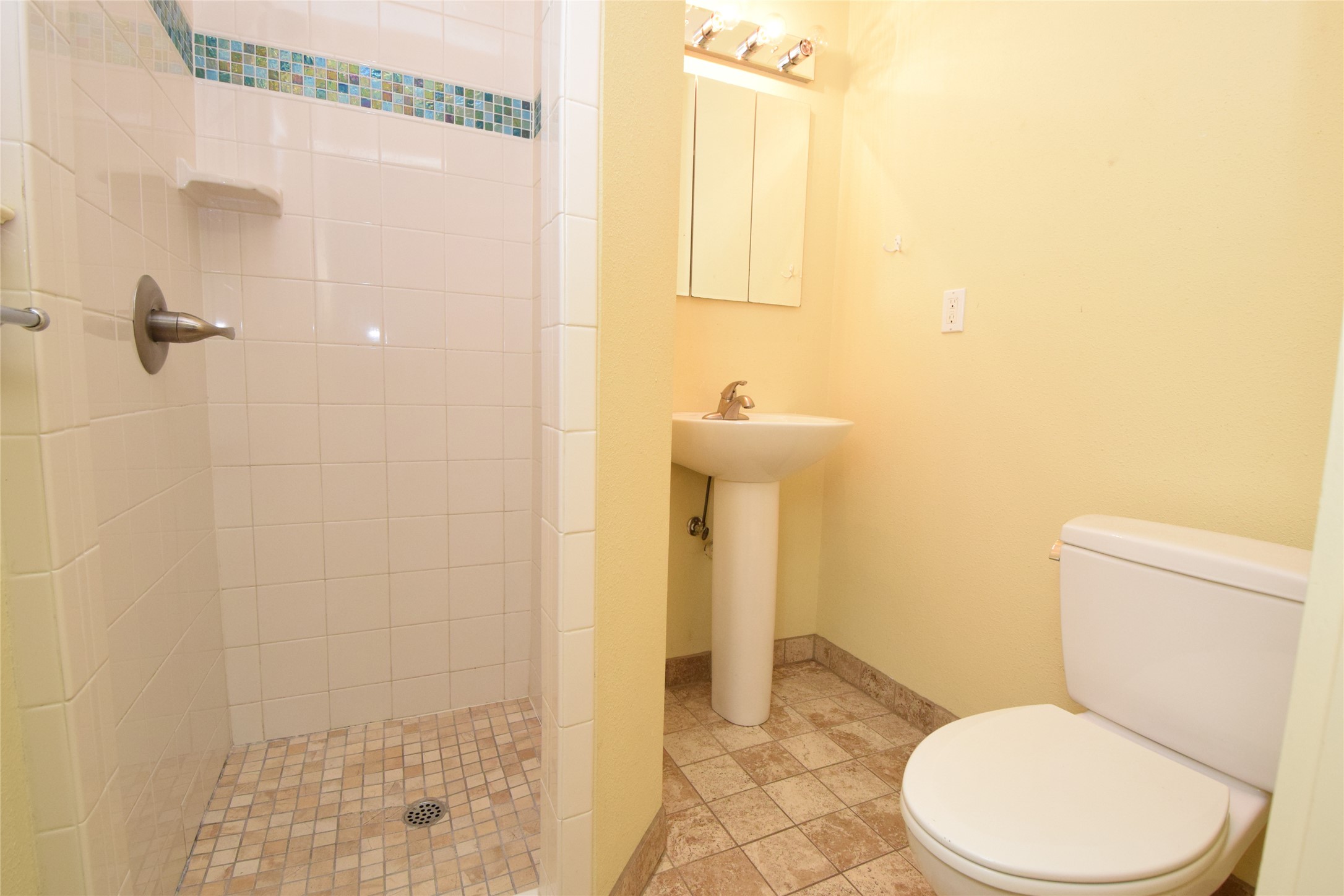 2801 Lafayette Avenue, Unit B Austin, TX 78722 - Photo 10 of 13 Bathroom with baseboards, a sink, a shower stall, and toilet