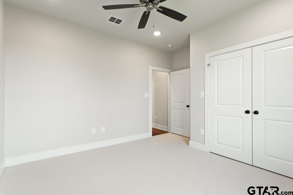 7173 Alexander Drive Tyler, TX 75707 - Photo 35 of 41 an empty room with a ceiling fan and window