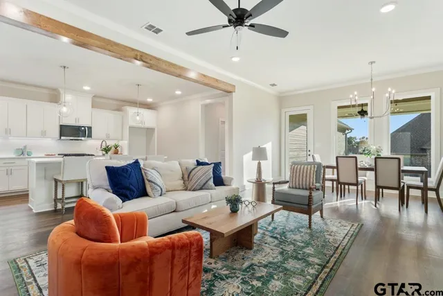 a living room with furniture and kitchen view