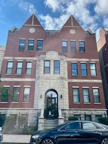 a front view of a building with windows and a street
