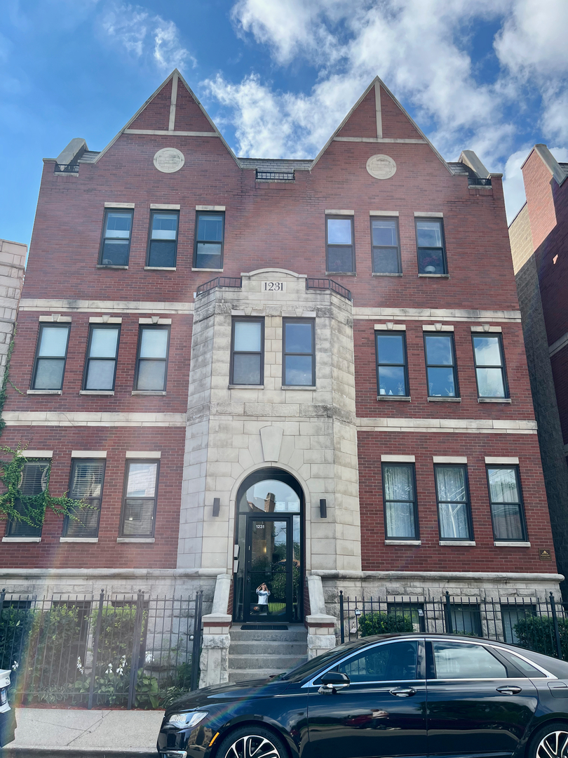 a front view of a building with windows and a street