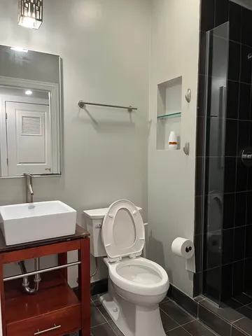 a bathroom with a sink toilet and a mirror