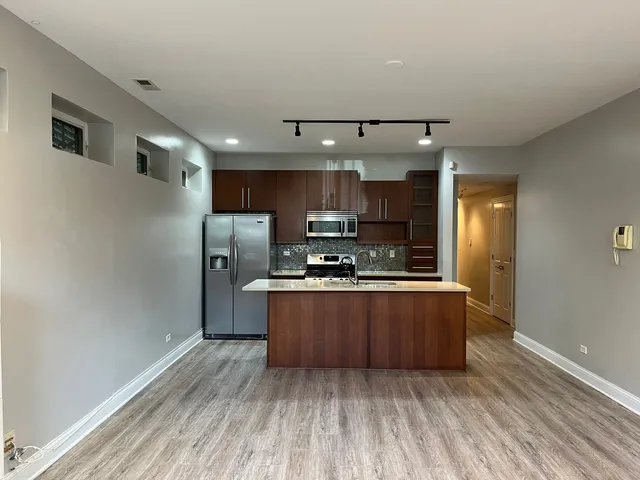 a kitchen with stainless steel appliances a refrigerator sink and cabinets