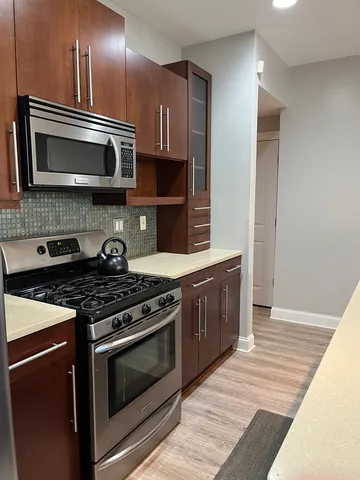 a kitchen with stainless steel appliances and cabinets