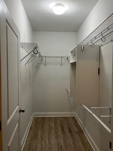 a view of a room with wooden floor and fan