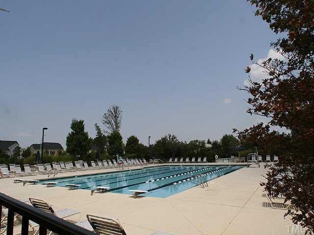 231 Broadgait Brae Road Cary, NC 27519 - Photo 3 of 3 a view of swimming pool with outdoor seating and trees in the background