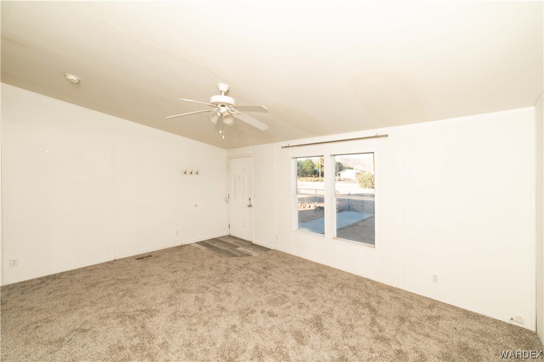 3329 Heber Road Golden Valley, AZ 86413 - Photo 40 of 52 an empty room with kitchen view and mirror