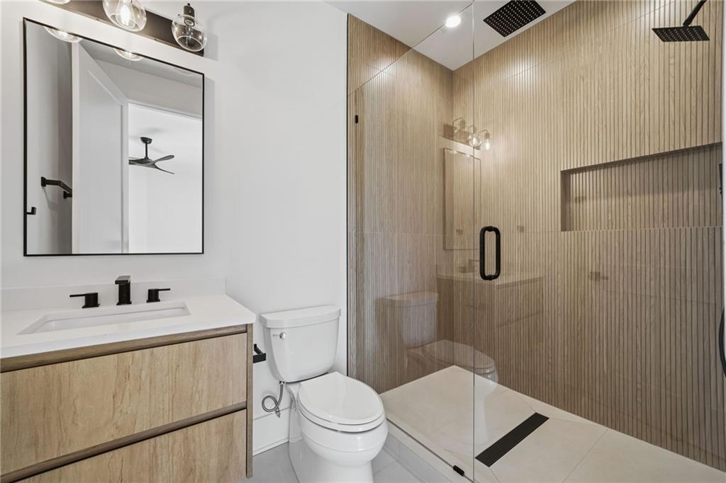 1185 Houston Mill Road Northeast Atlanta, GA 30329 - Photo 56 of 78 a bathroom with a toilet sink shower and mirror