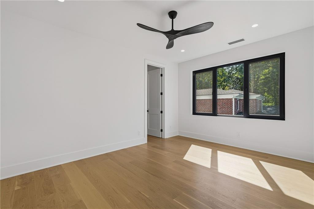 1185 Houston Mill Road Northeast Atlanta, GA 30329 - Photo 66 of 92 a view of an empty room with wooden floor and a window