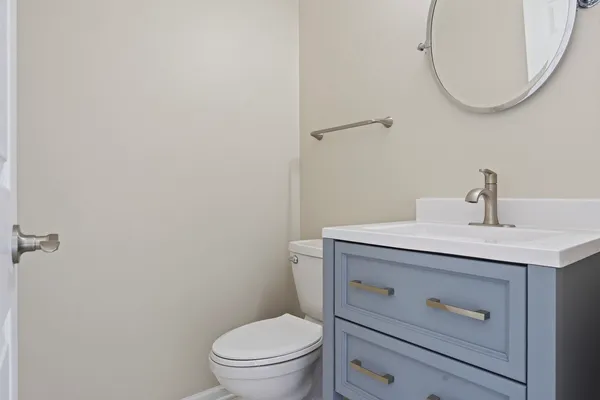 a bathroom with a sink a toilet and a mirror