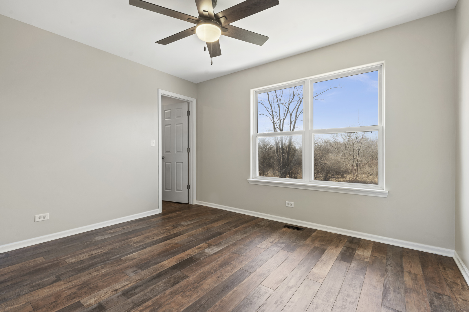 32804 Bending Creek Road McHenry, IL 60051 - Photo 27 of 42 a view of an empty room with wooden floor and a window
