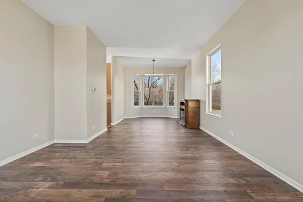 a view of a livingroom with wooden floor and a window