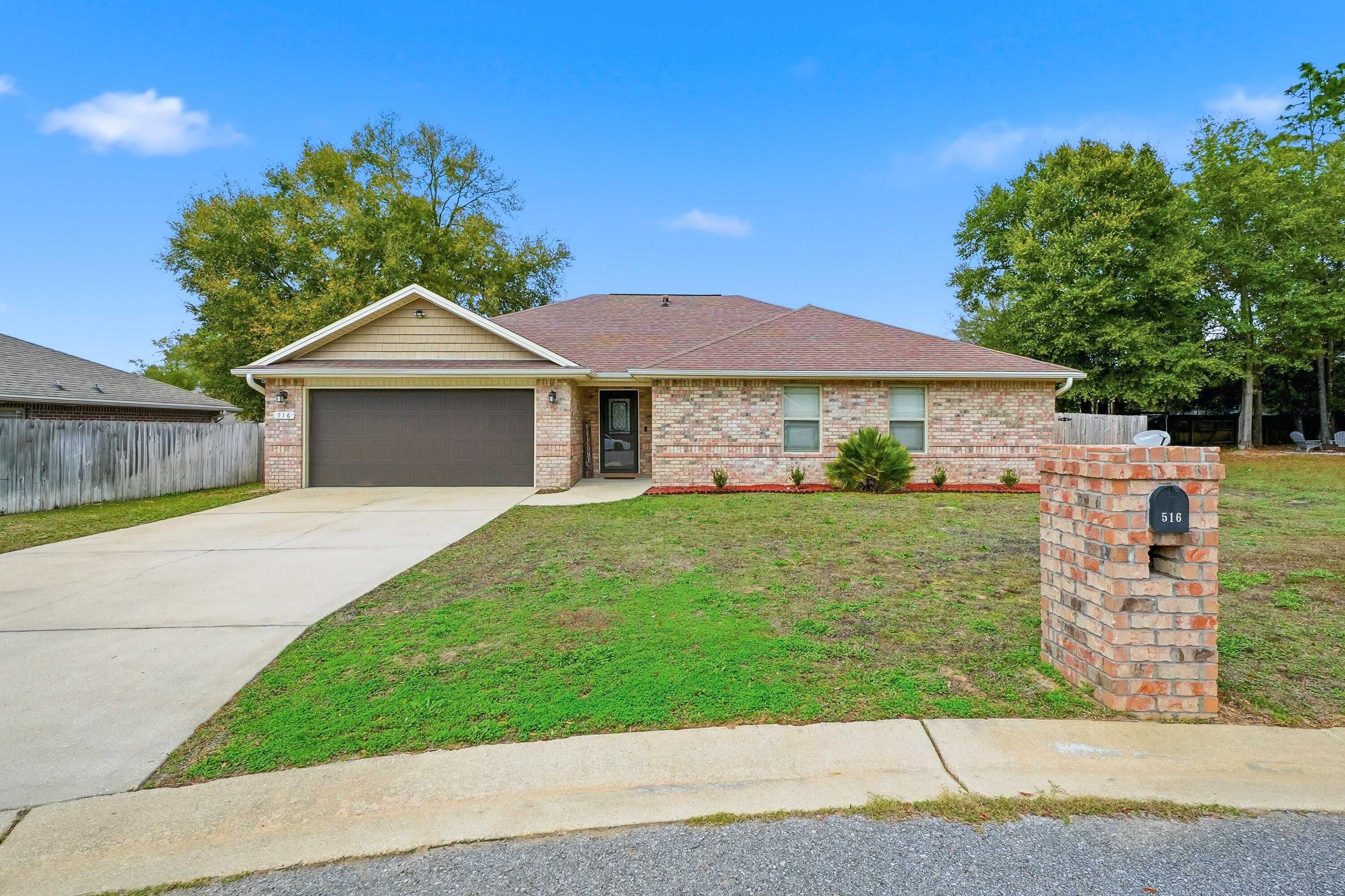 516 Grand Ridge Drive Crestview, FL 32539 - Photo 3 of 34 a front view of a house with a garden