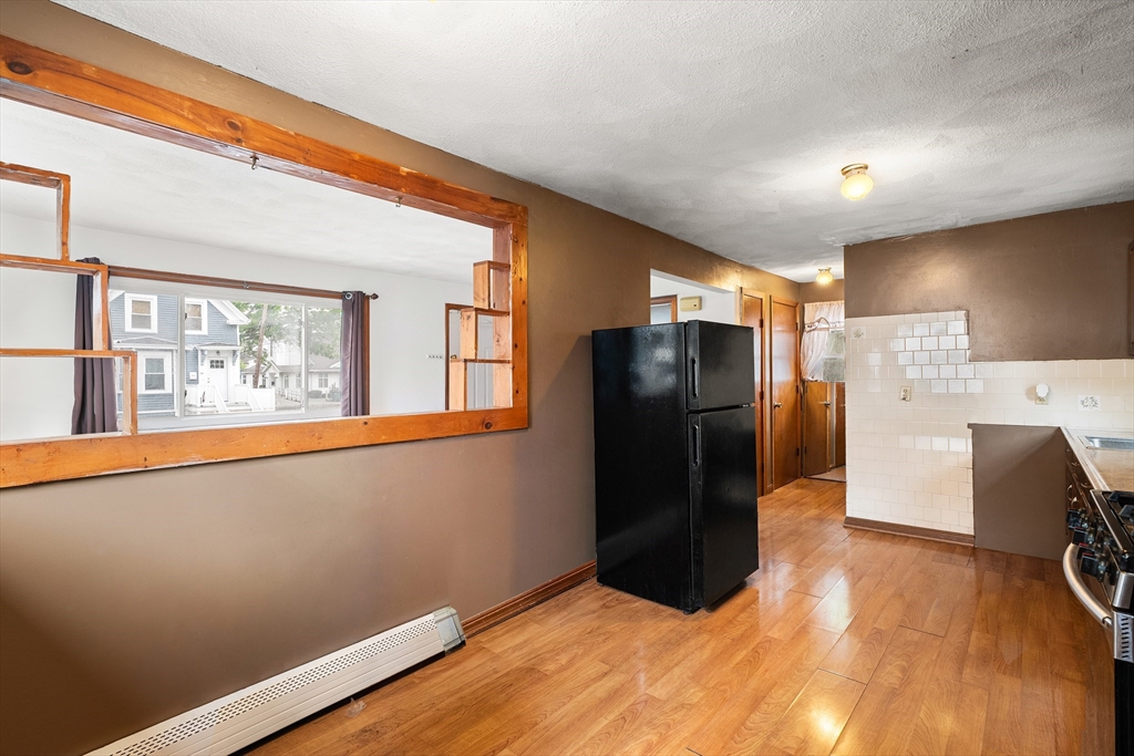 23 Logan Street Lynn, MA 01902 - Photo 7 of 27 a kitchen with stainless steel appliances a refrigerator and a stove