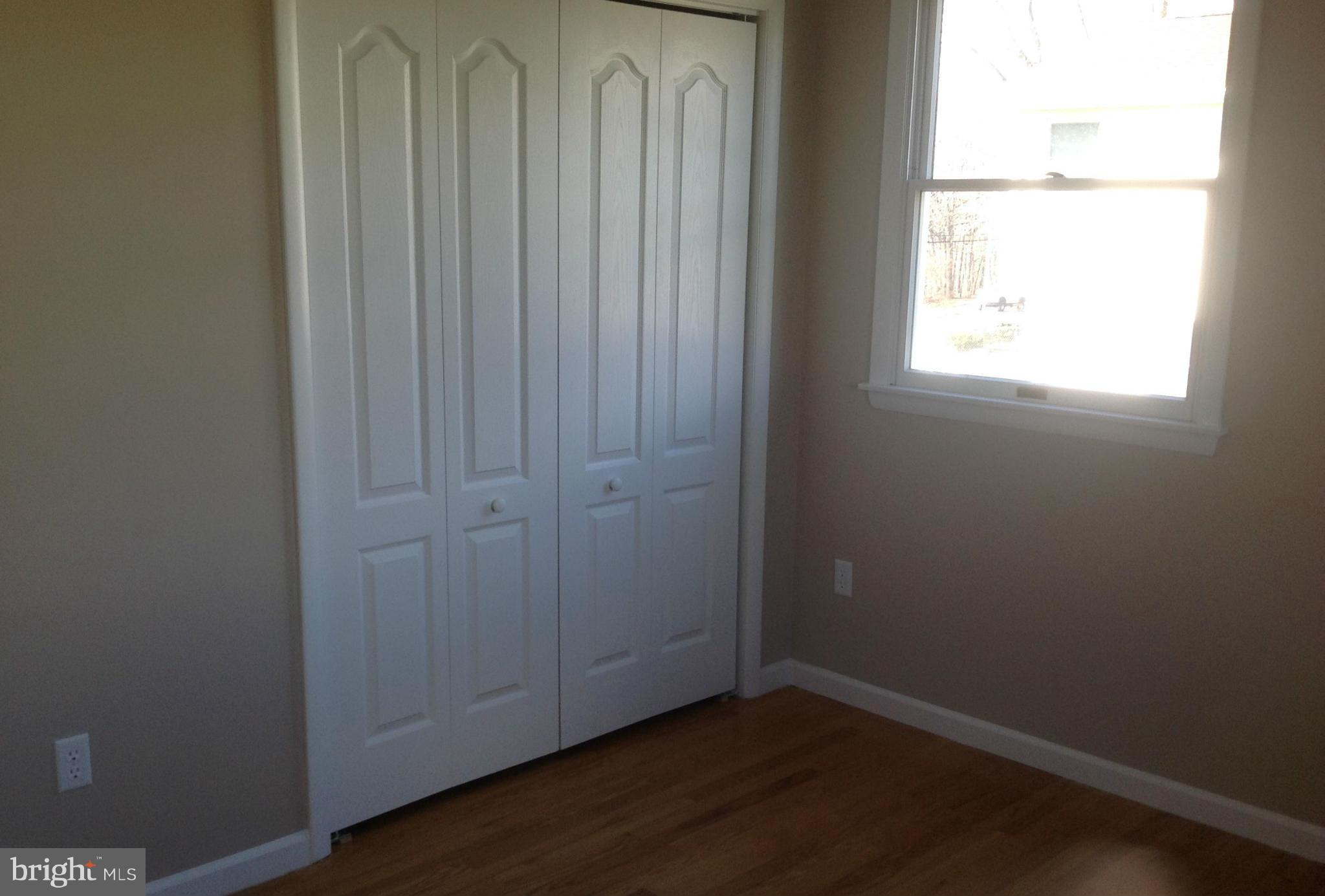 1218 Random Ridge Road Westminster, MD 21157 - Photo 14 of 15 an empty room with wooden floor closet and windows