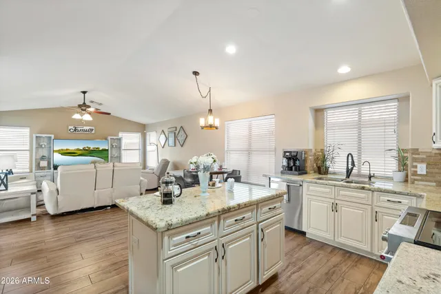 a bedroom with a bed and dresser with mirror
