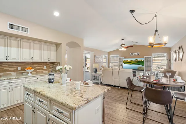 a bathroom with a granite countertop toilet a sink and a mirror