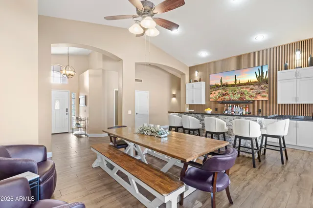 a living room with furniture a large window and a flat screen tv