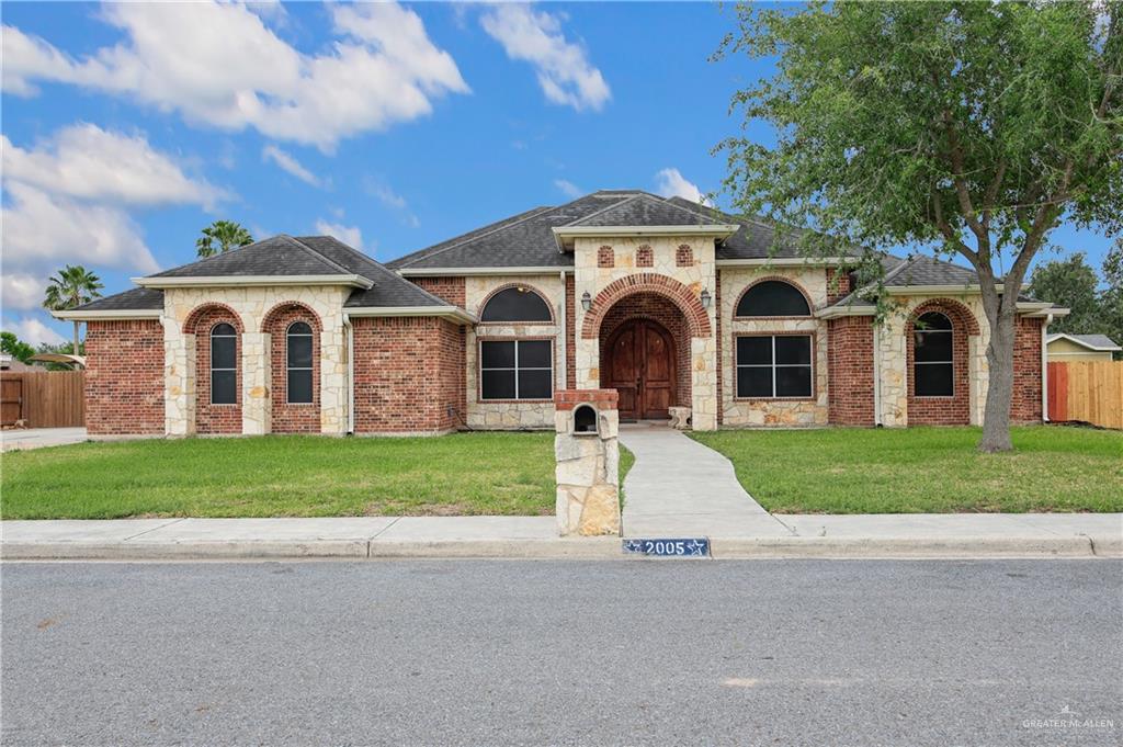2005 Stuart Road Weslaco, TX 78599 - Photo 2 of 30 a front view of a house with a garden