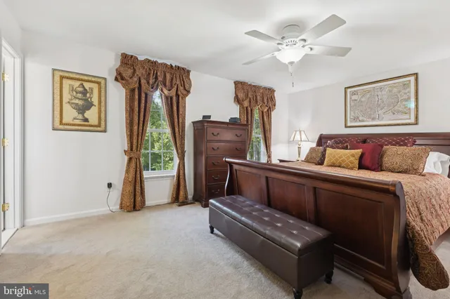 a bedroom with furniture and a fan