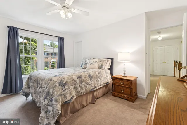 a spacious bedroom with a bed and a chandelier