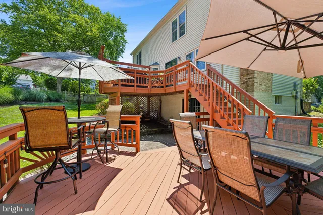 a view of a roof deck with table and chairs