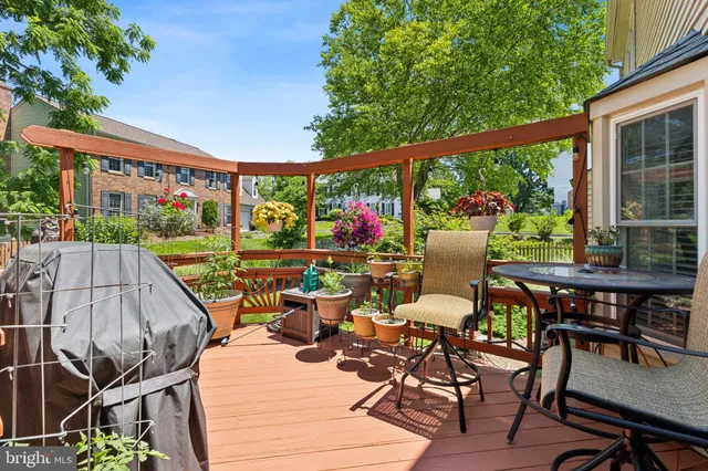 a view of a balcony with chairs and potted plants