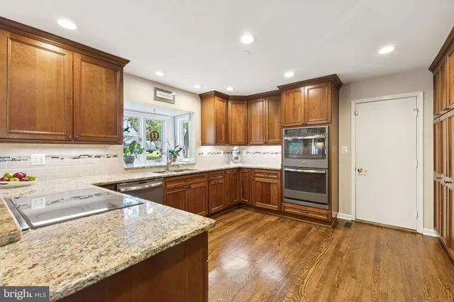 a kitchen with a sink a stove and cabinets