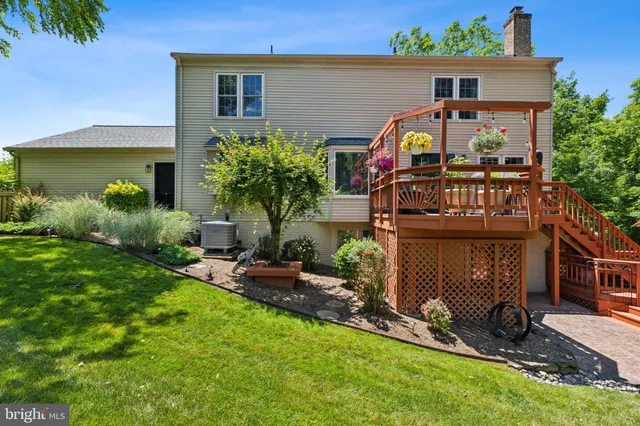 a view of a backyard with sitting area and garden